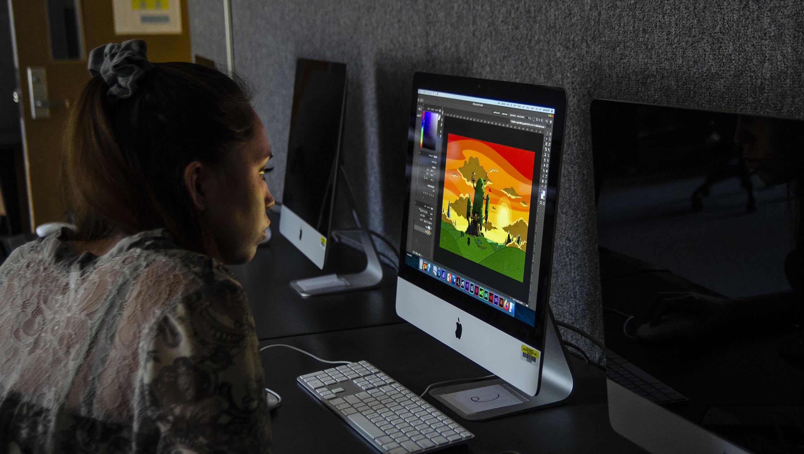 Student in computer lab working on digital art